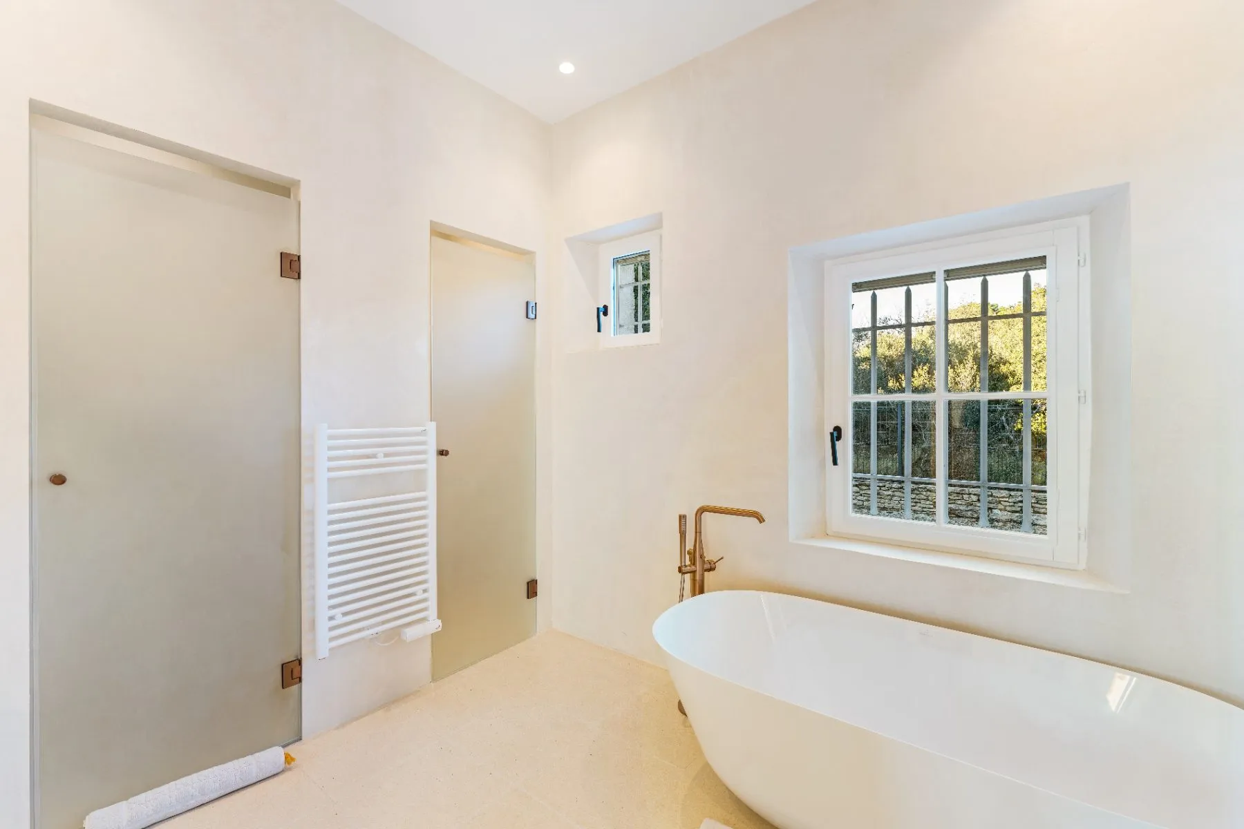 The main bathroom, bath and separate shower
