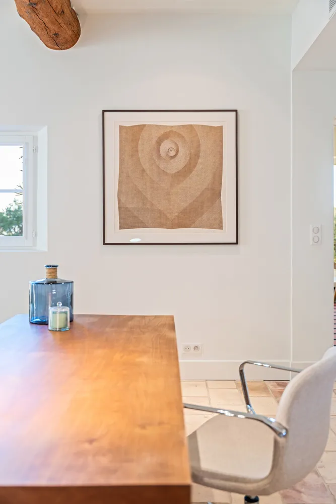 A corner of the house: a walnut table below a framed drawing