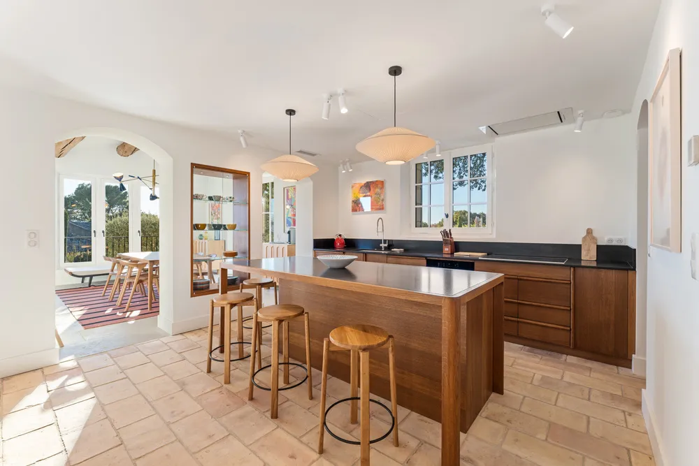 The kitchen island and breakfast bar, arch through to the dining room
